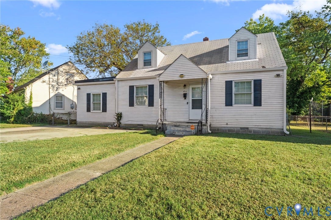 3917 Peyton Avenue, Richmond, VA 23224 White siding exterior with a pitched roof and multiple dormer windows