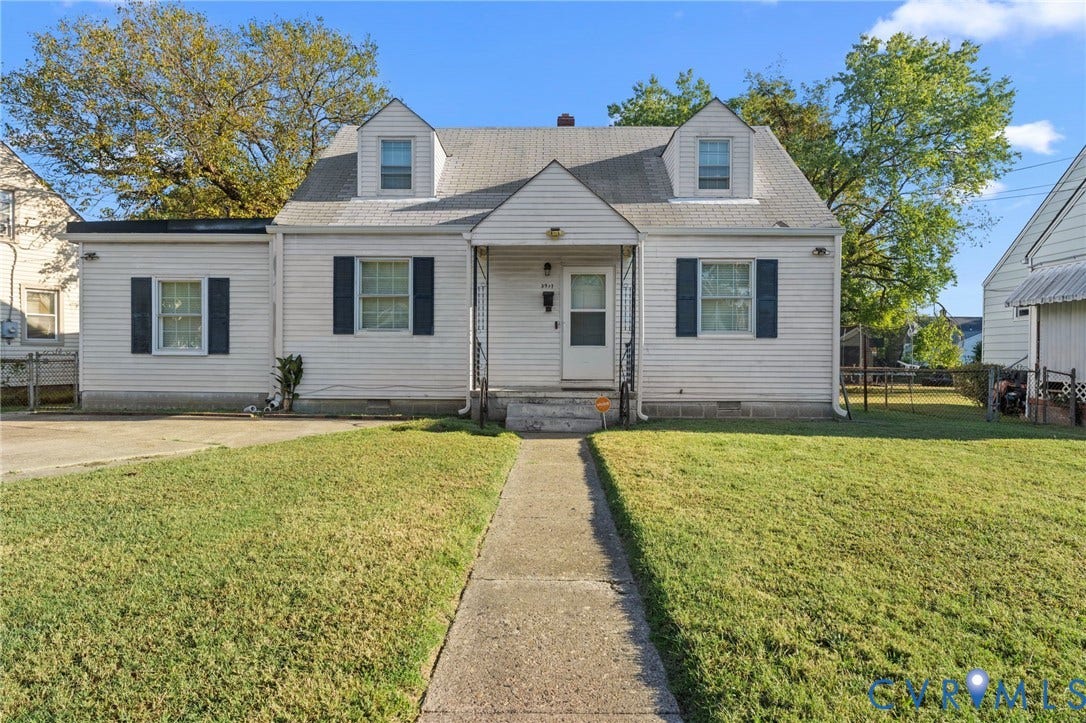 3917 Peyton Avenue, Richmond, VA 23224 White siding exterior with dark shutters, front walkway, and a manicured lawn