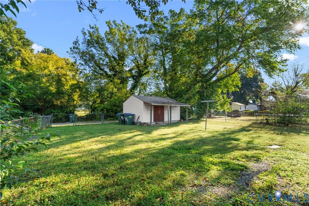 3917 Peyton Avenue, Richmond, VA 23224 Expansive lawn area with mature trees and a detached shed