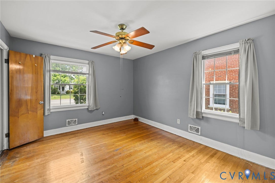 2405 Dumbarton Road, Henrico, VA 23228 Hardwood flooring with a ceiling fan, two windows, and a wood-finish door