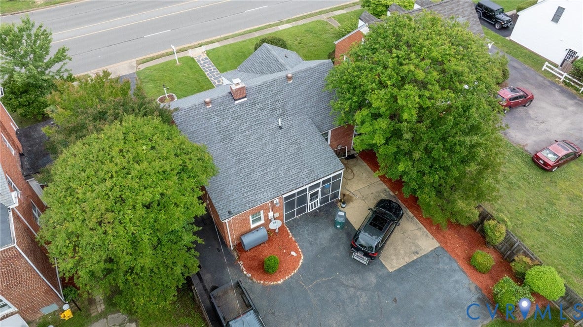 2405 Dumbarton Road, Henrico, VA 23228 Charming brick residence featuring a slate roof, updated exterior with blue accent trim, and mature landscaping