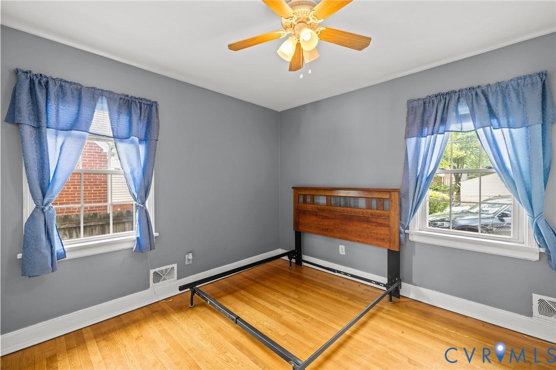2405 Dumbarton Road, Henrico, VA 23228 Hardwood flooring, two windows, ceiling fan with integrated lighting, and crown molding