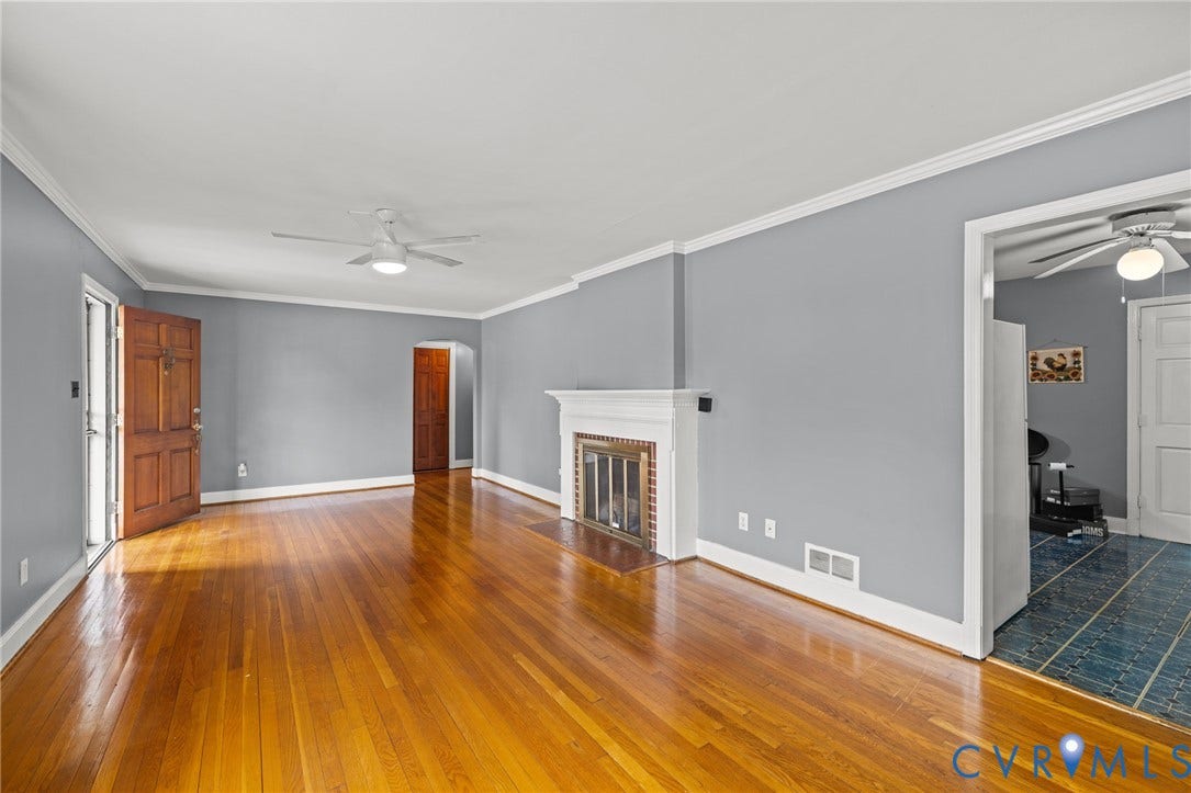 2405 Dumbarton Road, Henrico, VA 23228 Hardwood flooring, white crown molding, fireplace with white mantel, ceiling fans, and a wood-paneled door