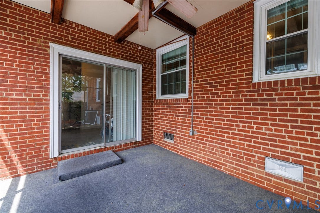 2405 Dumbarton Road, Henrico, VA 23228 Covered patio with a brick exterior, exposed wood beam ceiling, and a sliding glass door