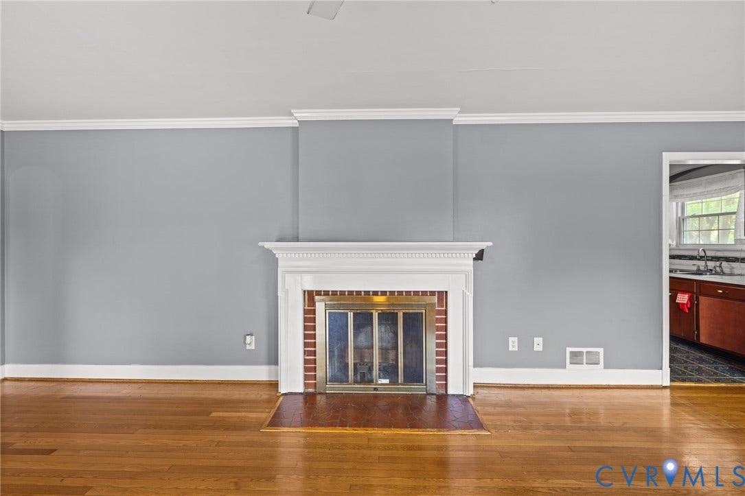 2405 Dumbarton Road, Henrico, VA 23228 Hardwood flooring, crown molding, fireplace with brick surround, fireplace mantel, and hearth