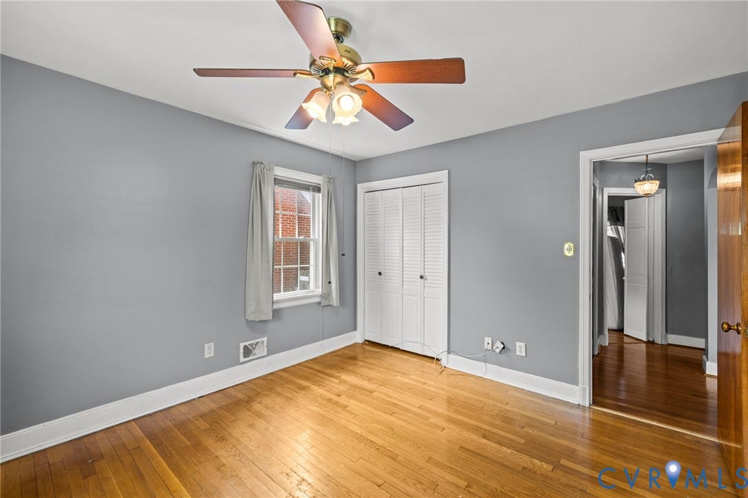 2405 Dumbarton Road, Henrico, VA 23228 Hardwood flooring, painted walls, ceiling fan with light fixture, window with grid panes, and bi-fold closet doors