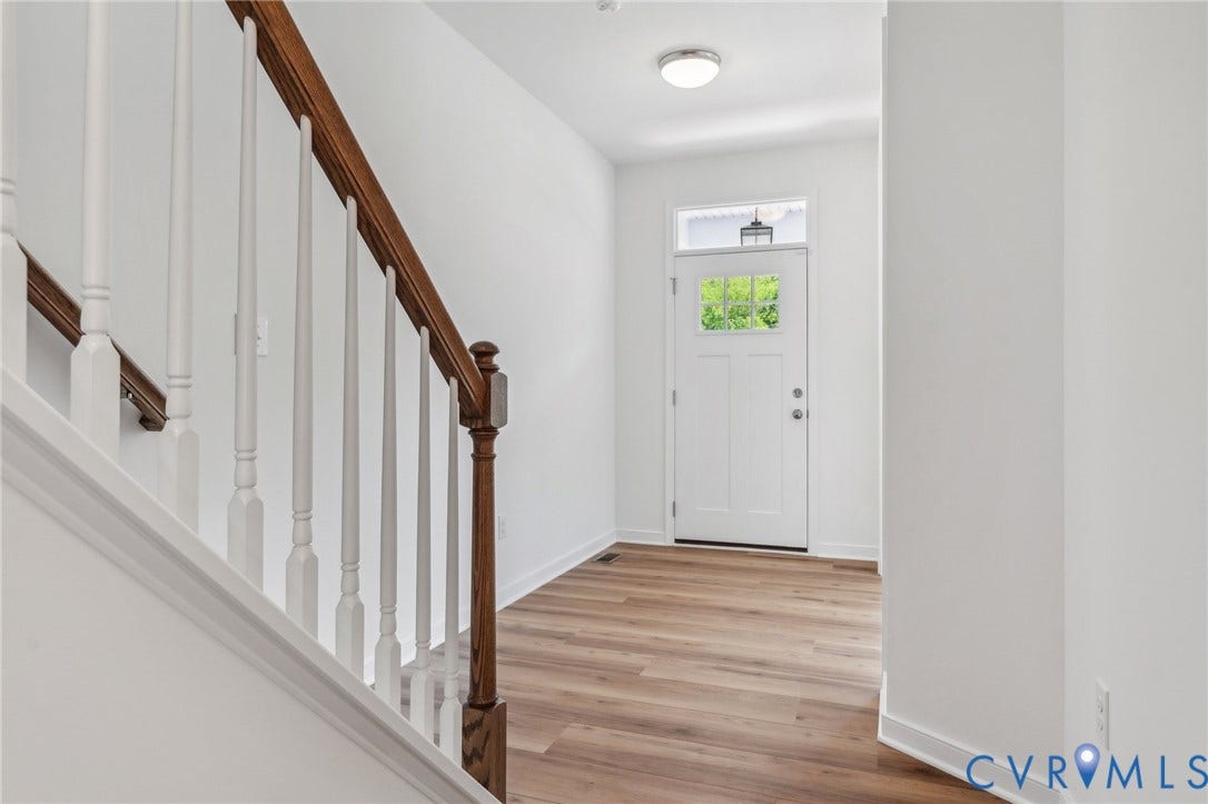 9116 TERROIR Lane, Viniterra Villas, New Kent, VA 23124 Entryway featuring wood-finish flooring, a solid white door with glass panels, and a transom window