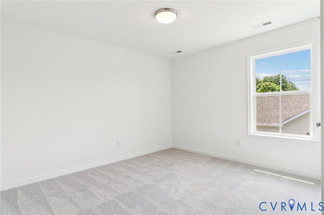 9116 TERROIR Lane, Viniterra Villas, New Kent, VA 23124 Bright interior with light-colored carpeting, a single window, and a flush-mount ceiling light fixture