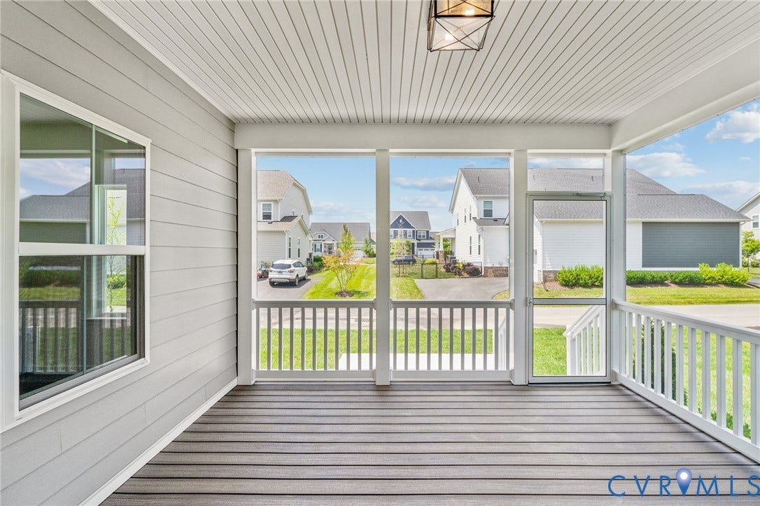9116 TERROIR Lane, Viniterra Villas, New Kent, VA 23124 Screened porch featuring wood-finish flooring, white railings, and a geometric ceiling light fixture