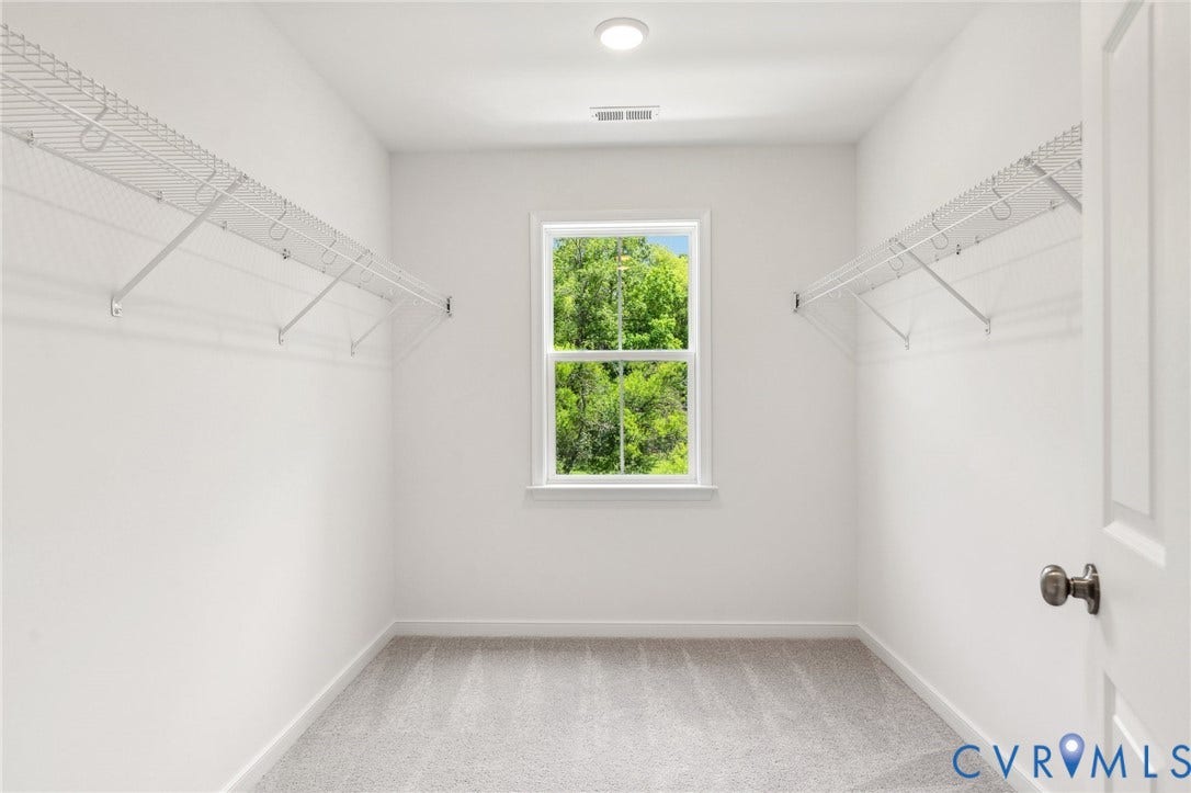 9116 TERROIR Lane, Viniterra Villas, New Kent, VA 23124 Carpeted room featuring a window, overhead lighting, and wire shelving