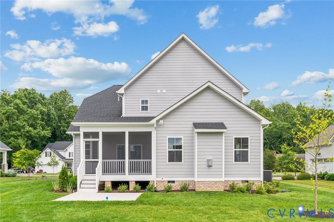 9116 TERROIR Lane, Viniterra Villas, New Kent, VA 23124 Two-story structure with light gray siding, dark shingle roof, screened porch, and a concrete patio
