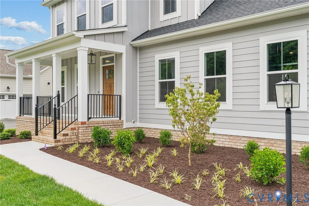 9116 TERROIR Lane, Viniterra Villas, New Kent, VA 23124 Covered front porch with white columns, brick foundation, and wrought iron railings