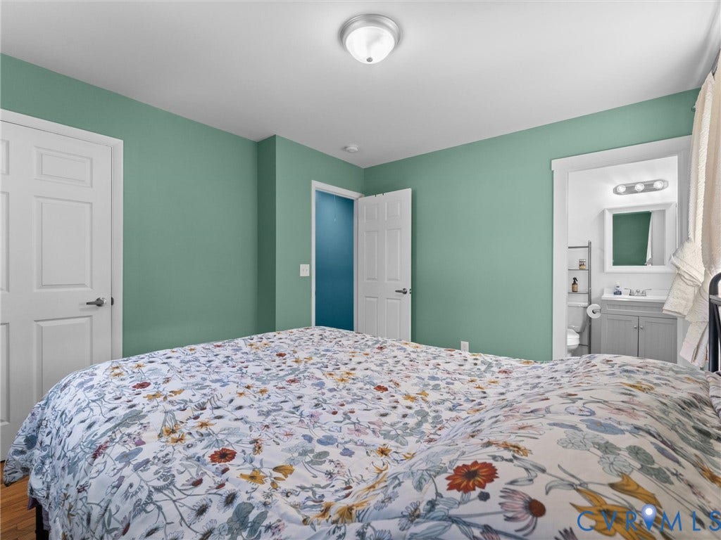 Recessed lighting, wood-finish flooring, white paneled doors, and a ceiling-mounted light fixture