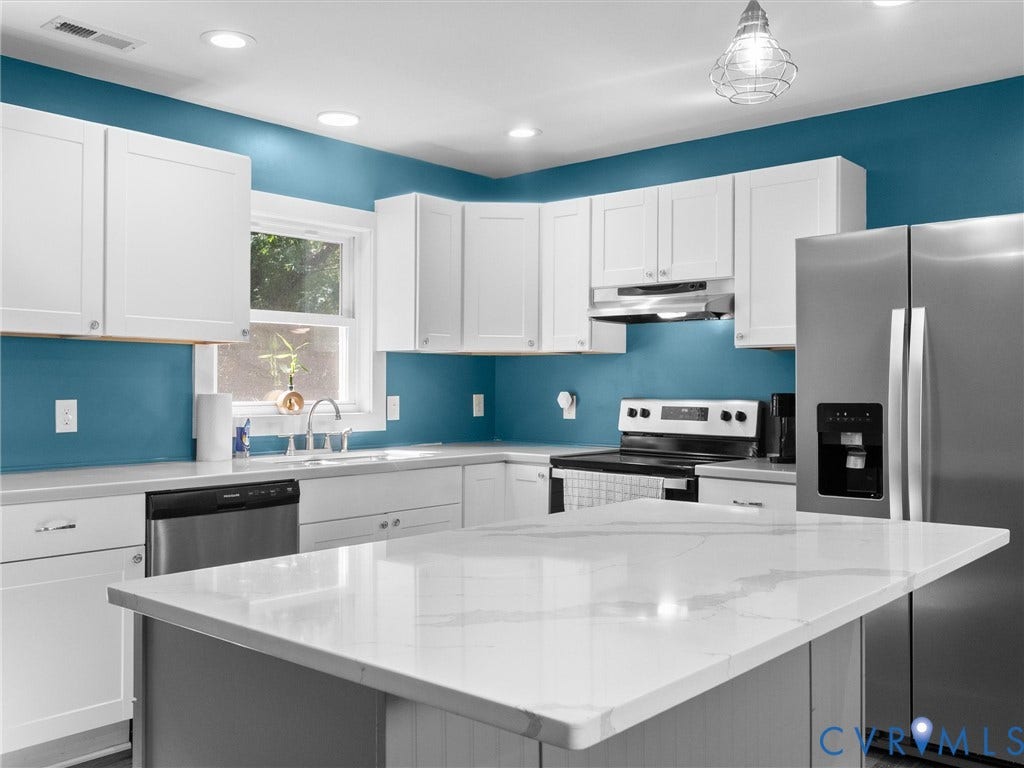 Kitchen featuring white shaker cabinetry, stainless steel appliances, recessed lighting, a center island with a stone-finish countertop, and a stainless steel sink with a gooseneck faucet