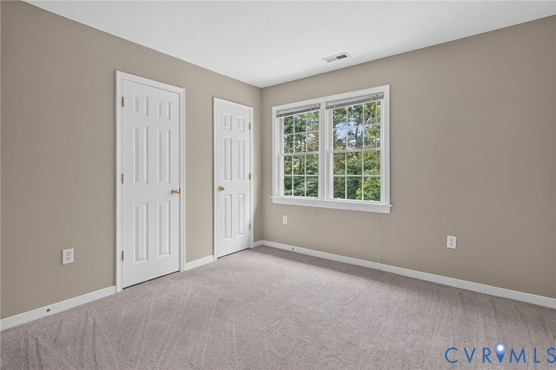 Neutral-toned walls, light gray carpet, and white trim