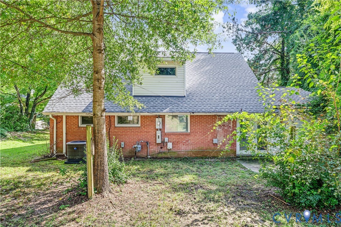 Brick exterior with a gray shingle roof, complemented by white siding