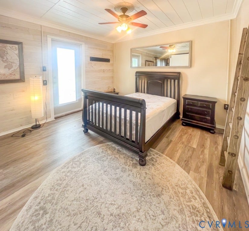 511 Riverview Court, Chester, VA 23836 Wood-finish flooring, ceiling fan, and a light-colored wood panel accent wall
