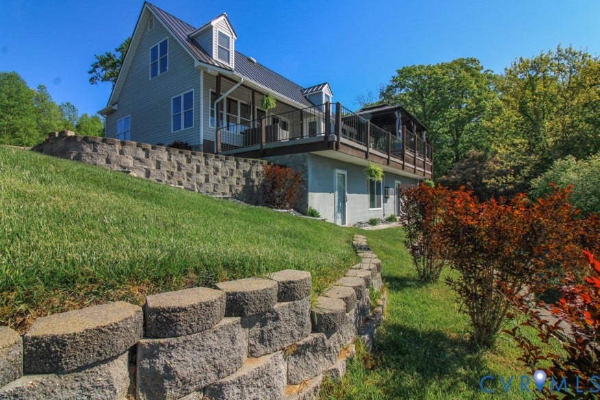 511 Riverview Court, Chester, VA 23836 Multi-level residence featuring a metal roof, dormer windows, and a raised deck with protective railing