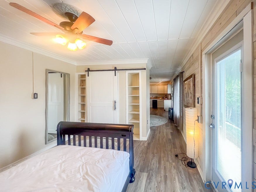 511 Riverview Court, Chester, VA 23836 Wood-finish flooring throughout, white panel ceiling, white barn door, built-in shelving, and white trim