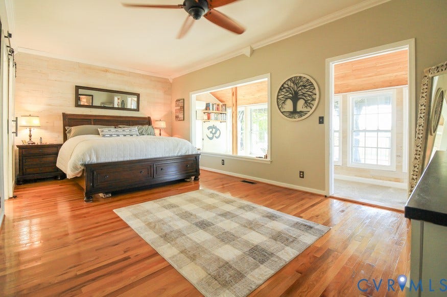 511 Riverview Court, Chester, VA 23836 Hardwood flooring, ceiling fan, accent wall with horizontal paneling, crown molding, and an interior window