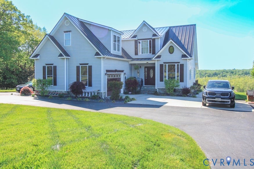 511 Riverview Court, Chester, VA 23836 Two-story residential exterior with light blue siding, black-framed windows, and a dark metal roof