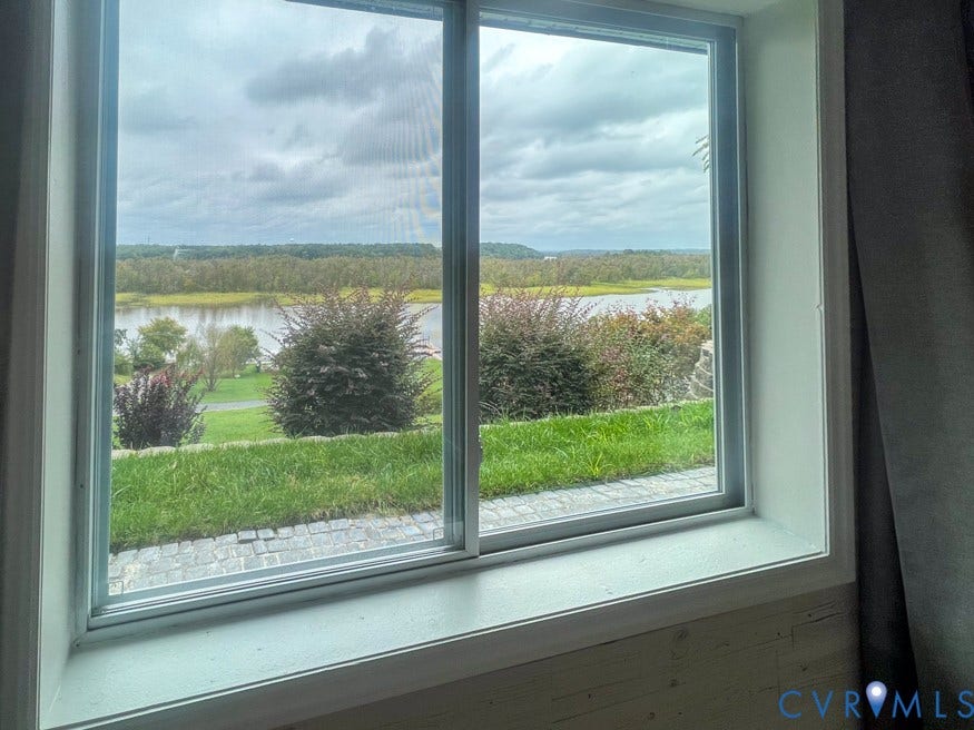 511 Riverview Court, Chester, VA 23836 Sliding window overlooking a body of water, green landscape, and distant tree line