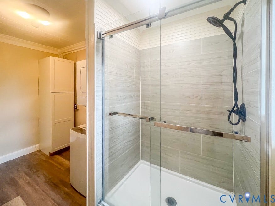 511 Riverview Court, Chester, VA 23836 Glass-enclosed shower with a modern dark-finish shower head and tiled walls