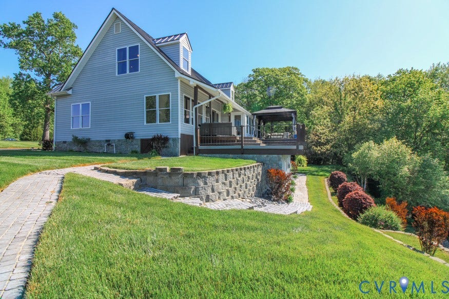 511 Riverview Court, Chester, VA 23836 Multi-level deck with a built-in gazebo, light blue siding, stone retaining wall, and a paver pathway