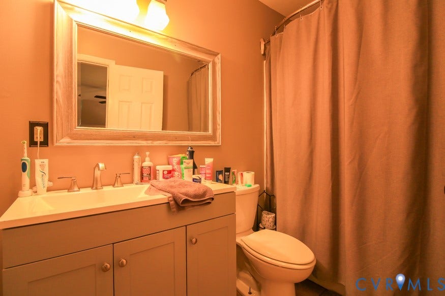 511 Riverview Court, Chester, VA 23836 Vanity with integrated sink, framed mirror, and two-handle faucet
