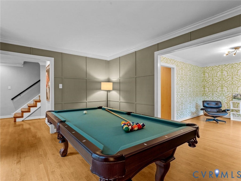 12100 English Ivy Lane, Glen Allen, VA 23059 Wood-finish flooring, grid-pattern wall molding, crown molding, and staircase with dark-finish handrail