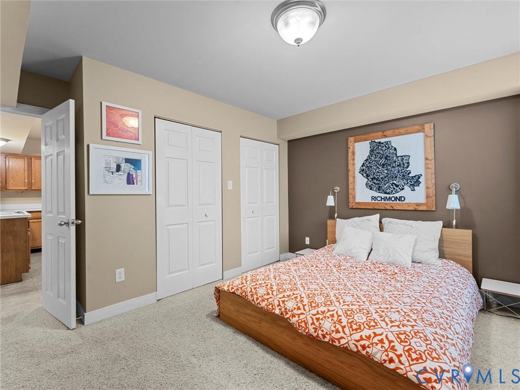 12100 English Ivy Lane, Glen Allen, VA 23059 Neutral-toned interior featuring wall-to-wall carpeting, two sets of white paneled closet doors, and a flush-mount ceiling fixture