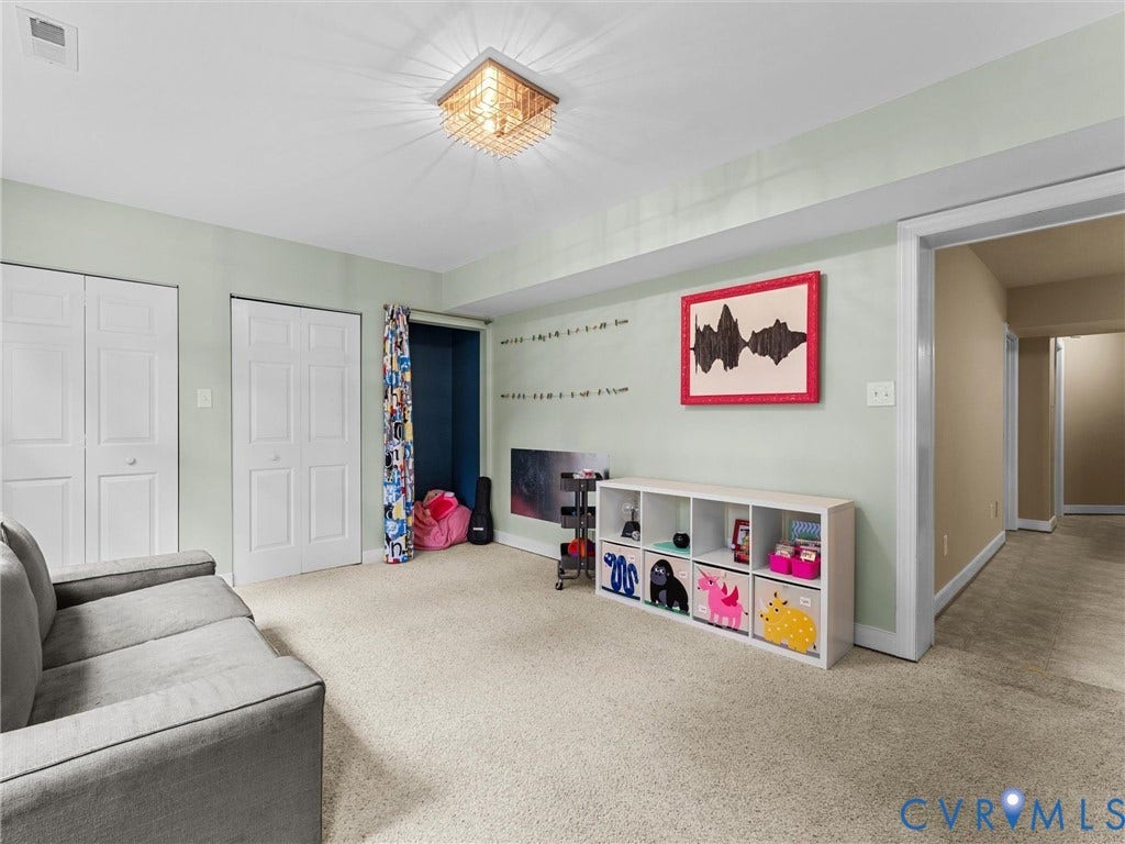12100 English Ivy Lane, Glen Allen, VA 23059 Interior room featuring wall-to-wall carpeting, dual closets with white paneled doors, square geometric ceiling light fixture, and neutral wall paint