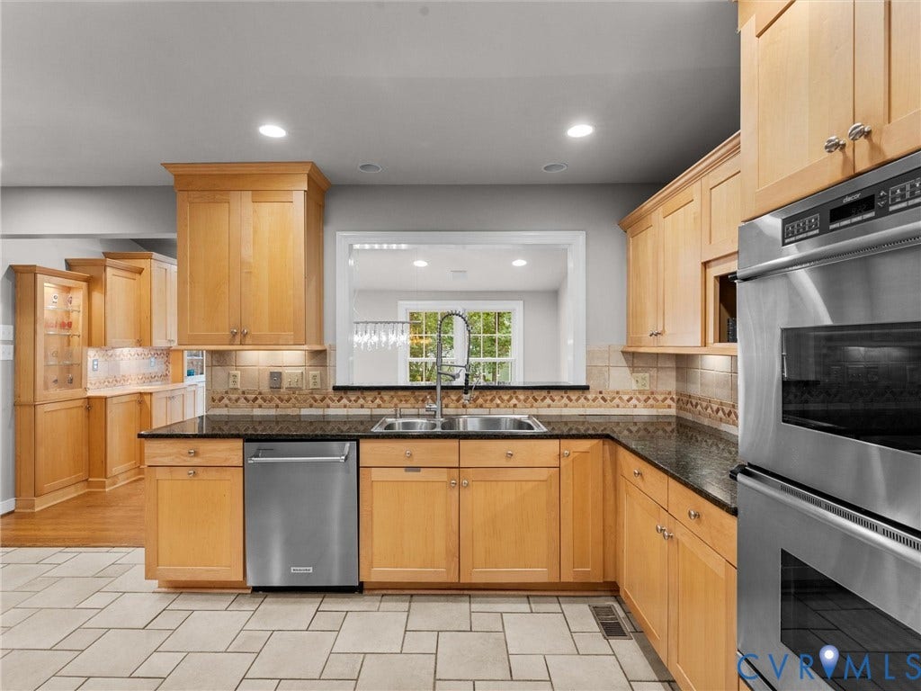 12100 English Ivy Lane, Glen Allen, VA 23059 Kitchen featuring light-finish cabinetry, dark stone countertops, stainless steel appliances, a double-basin undermount sink, and tile flooring
