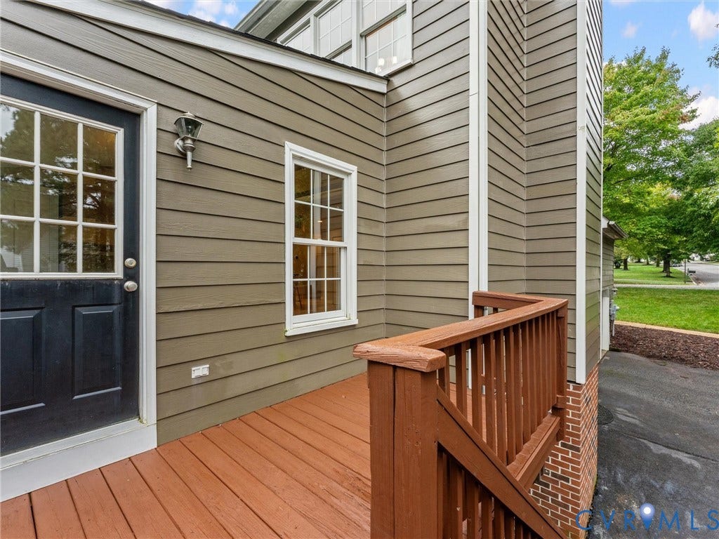12100 English Ivy Lane, Glen Allen, VA 23059 Exterior featuring horizontal lap siding, a wooden deck with railing, a paneled door with glass inserts, and brick foundation trim