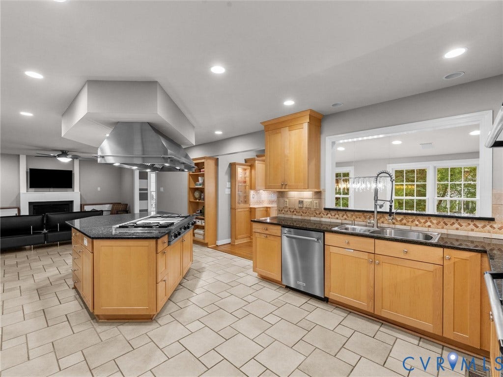 12100 English Ivy Lane, Glen Allen, VA 23059 Kitchen featuring light wood cabinetry, stone countertops, a large center island with a stainless steel range hood, stainless steel appliances, and tile flooring