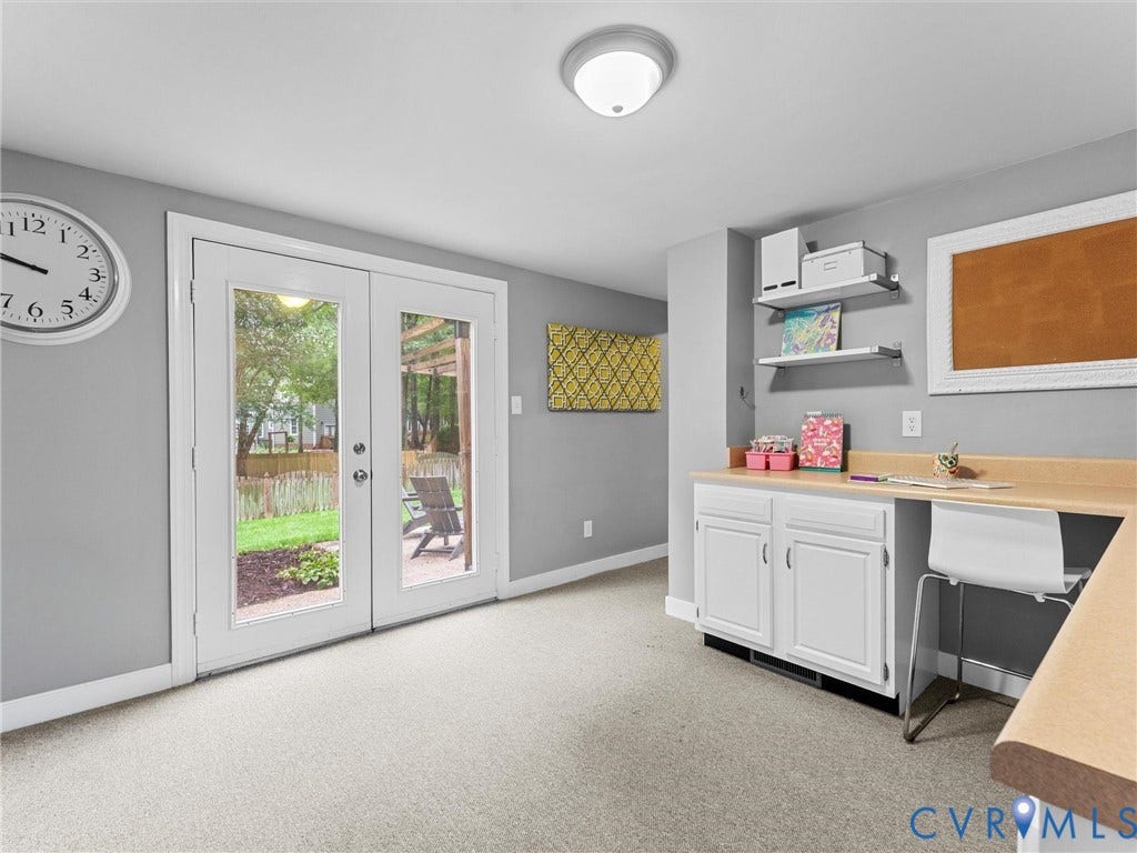 12100 English Ivy Lane, Glen Allen, VA 23059 Double glass-pane French doors, neutral carpeting, white built-in cabinetry with a solid-surface countertop, and two floating wall-mounted shelves