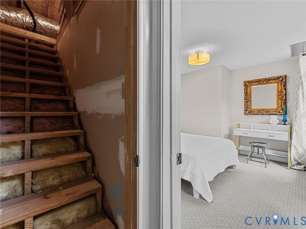 12100 English Ivy Lane, Glen Allen, VA 23059 Unfinished stairway with exposed wooden framing and insulation, featuring neutral-toned carpeting and a drum-style flush mount ceiling fixture