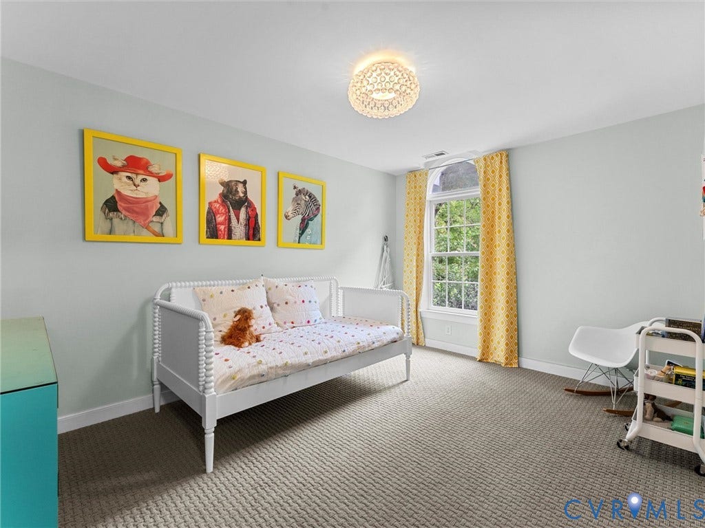 12100 English Ivy Lane, Glen Allen, VA 23059 Neutral-toned wall interior featuring a textured carpeted floor, decorative ceiling flush-mount light fixture, and an arched top window with trim casing