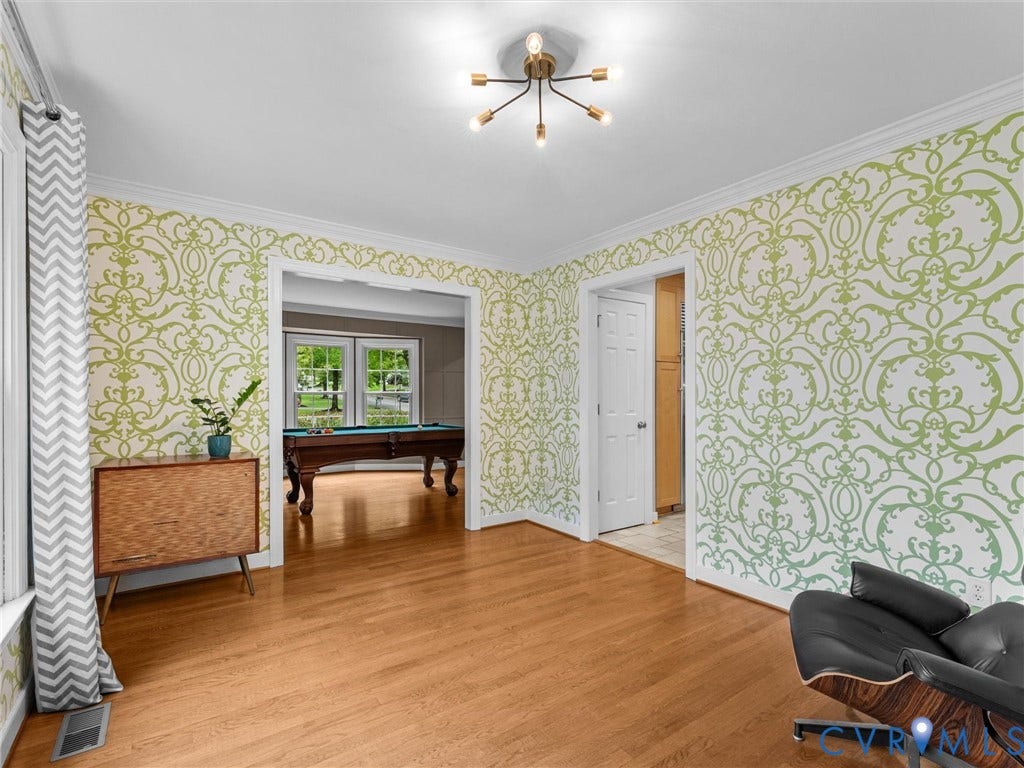 12100 English Ivy Lane, Glen Allen, VA 23059 Living area featuring wood-finish flooring, patterned wall coverings, crown molding, and a multi-arm modern light fixture