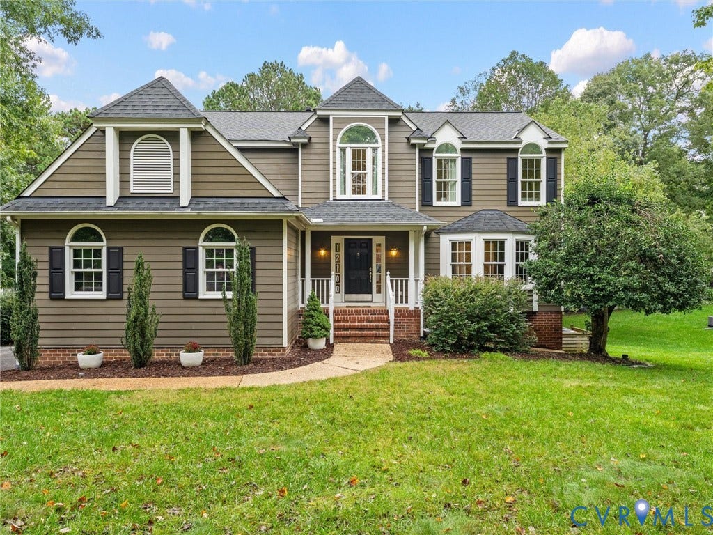 12100 English Ivy Lane, Glen Allen, VA 23059 Two-story traditional exterior featuring horizontal siding, brick foundation accents, a covered front porch with brick steps, multiple arched windows, and a paved walkway