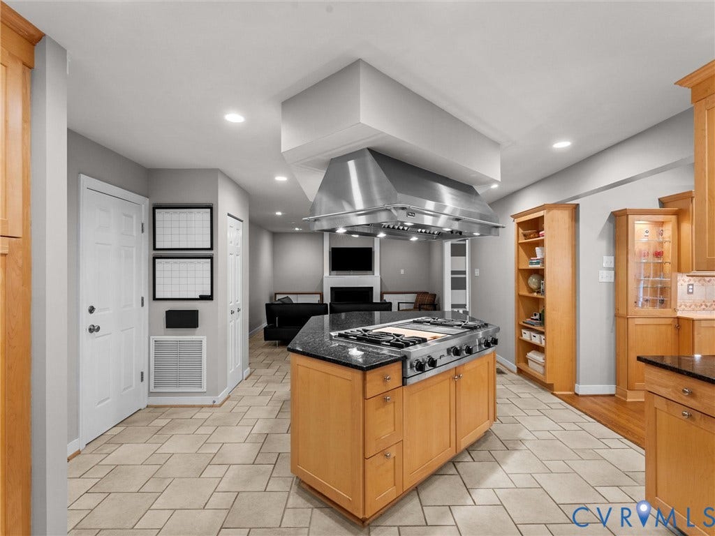 12100 English Ivy Lane, Glen Allen, VA 23059 Kitchen featuring a center island with an integrated cooktop, stainless steel professional-grade range hood, built-in cabinetry, and tile flooring