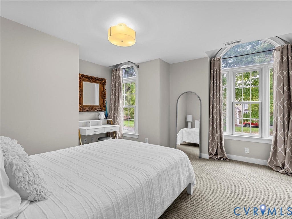 12100 English Ivy Lane, Glen Allen, VA 23059 Room featuring wall-to-wall carpeting, multiple arched windows with overhead transom panes, and a flush-mount circular drum light fixture