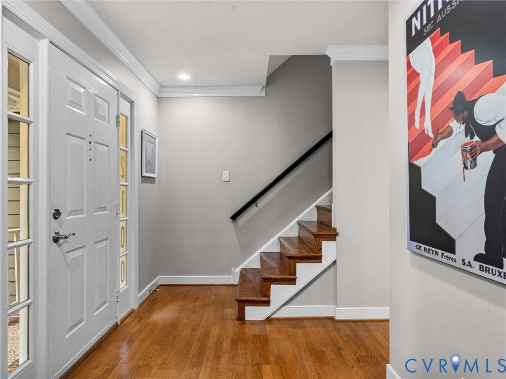 12100 English Ivy Lane, Glen Allen, VA 23059 Entryway featuring wood-finish flooring, staircase with natural wood treads, crown molding, and a paneled front door with sidelights