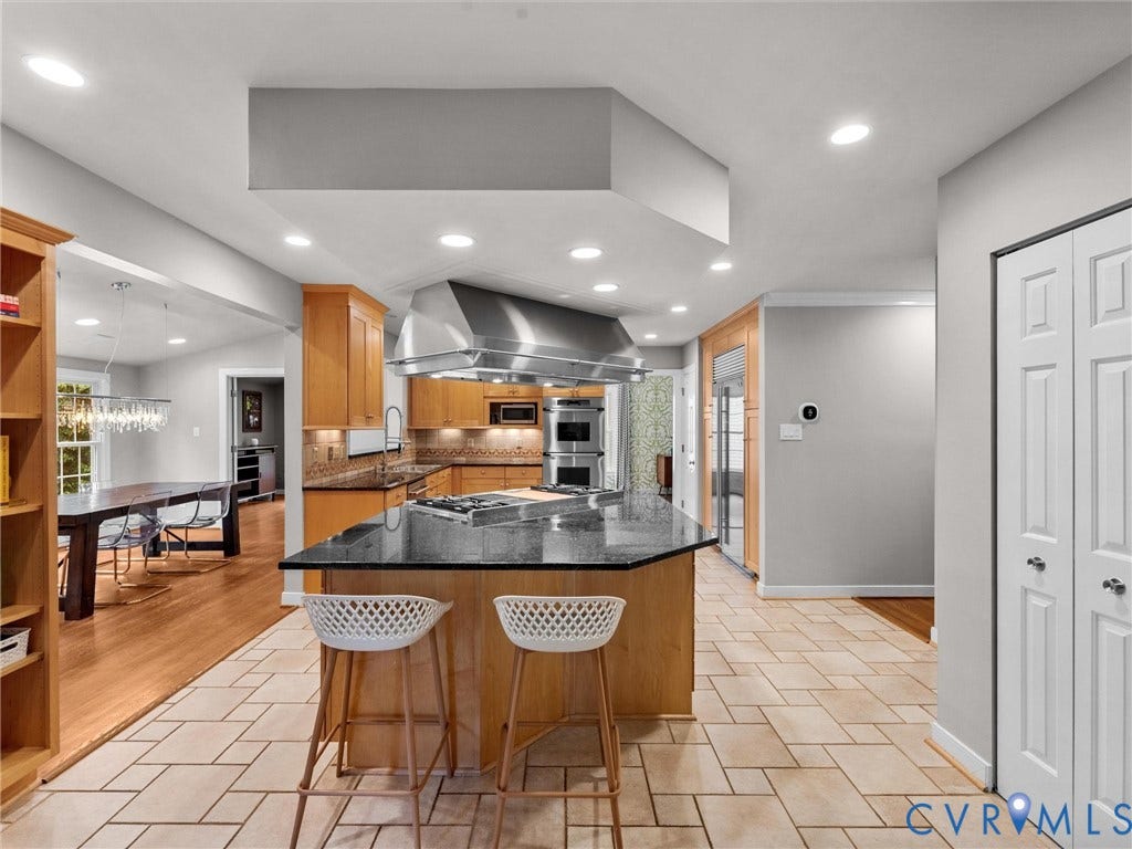 12100 English Ivy Lane, Glen Allen, VA 23059 Kitchen featuring a large central island with a gas cooktop, overhead stainless steel vent hood, wood cabinetry, stone countertops, and recessed lighting
