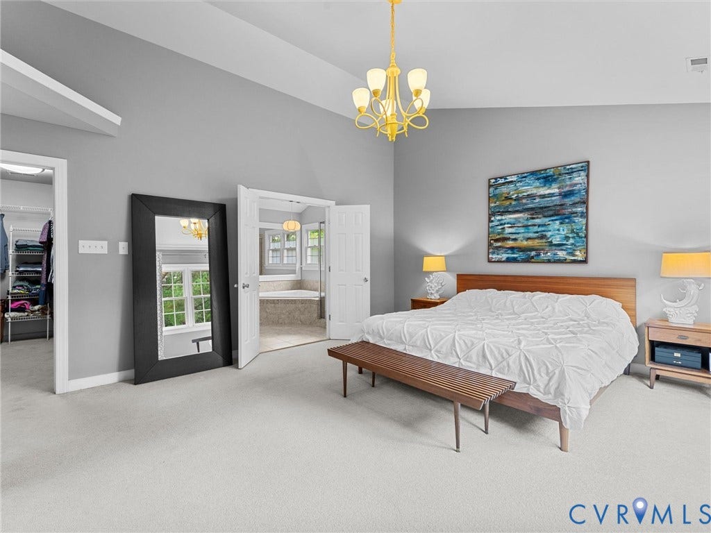 12100 English Ivy Lane, Glen Allen, VA 23059 Vaulted ceiling featuring a central multi-light chandelier, neutral carpeting, and double-door entry to a tiled room