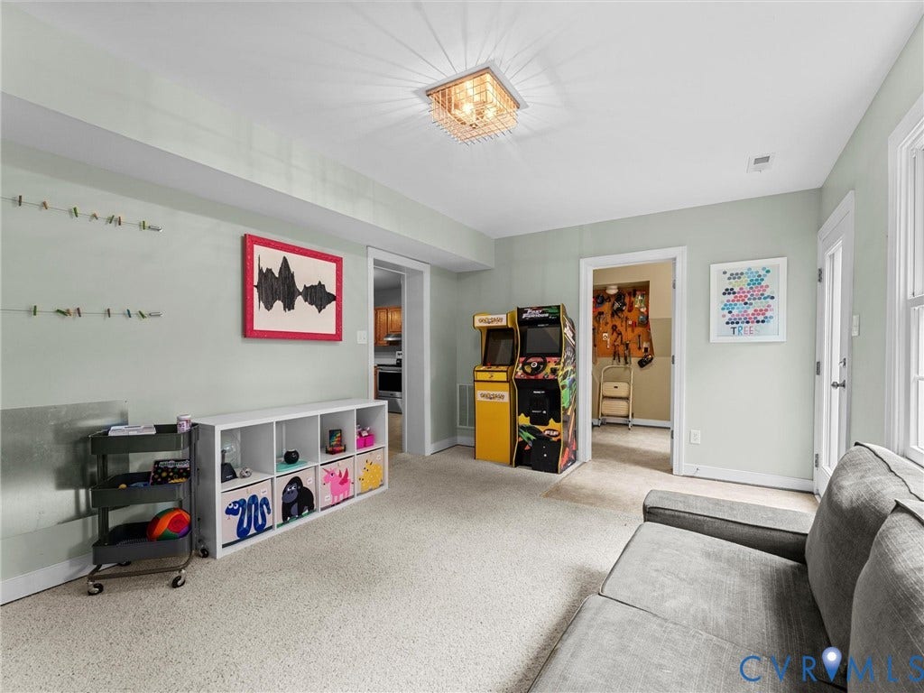 12100 English Ivy Lane, Glen Allen, VA 23059 Neutral wall-toned room featuring high-pile carpeting, a tiered glass-paneled ceiling light fixture, and a glass-paneled exterior door