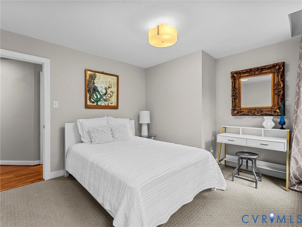 12100 English Ivy Lane, Glen Allen, VA 23059 Neutral-toned room featuring wall-to-wall carpeting, wood-finish flooring in the entryway, and a semi-flush mount ceiling fixture