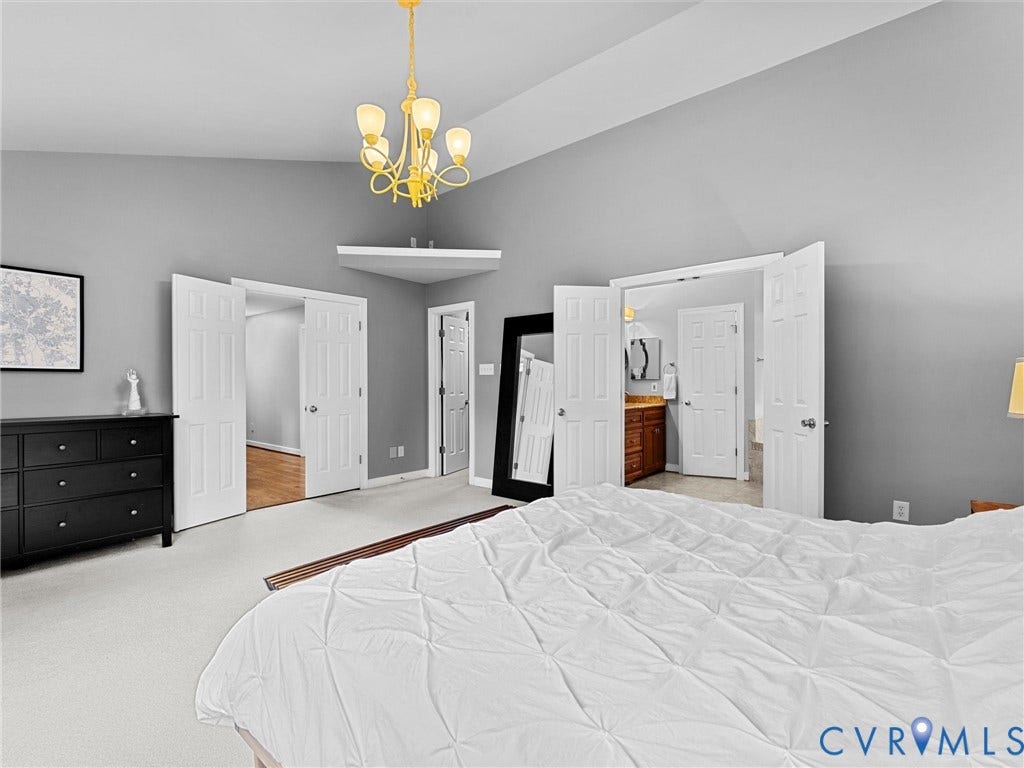 12100 English Ivy Lane, Glen Allen, VA 23059 Vaulted ceilings, five-light brass finish chandelier, and multi-panel interior doors
