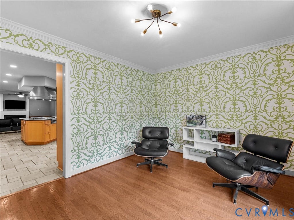 12100 English Ivy Lane, Glen Allen, VA 23059 Room featuring wood-finish flooring, patterned wallcovering, crown molding, and a multi-arm modern light fixture