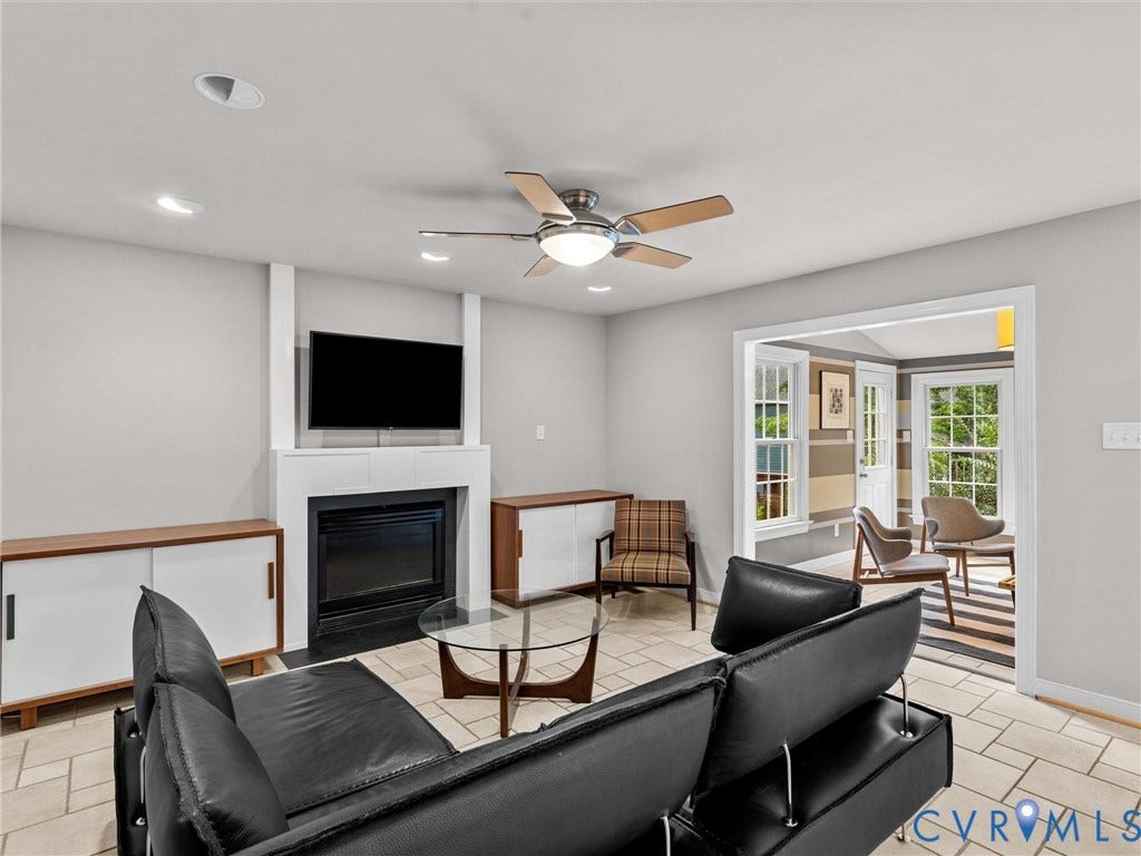 12100 English Ivy Lane, Glen Allen, VA 23059 Living area featuring a fireplace with a white mantel surround, tile flooring, built-in cabinetry, and a ceiling fan